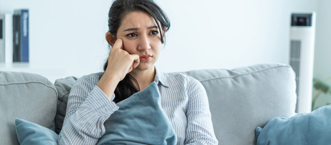 frustrated woman sitting on couch