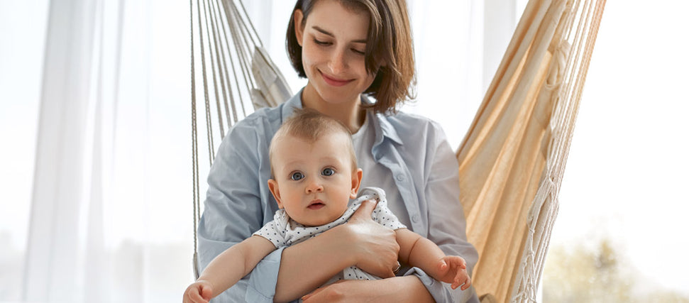 mom and baby sitting on hammock