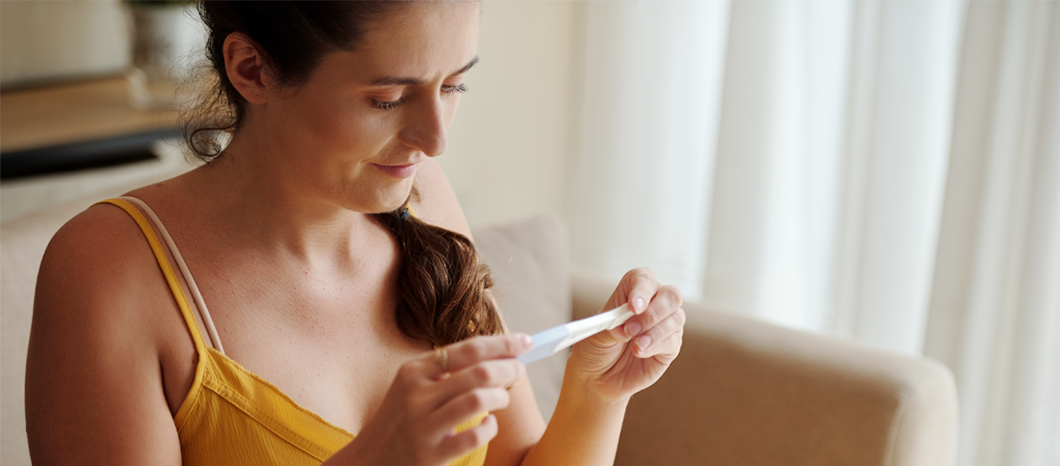 woman looking at ovulation test