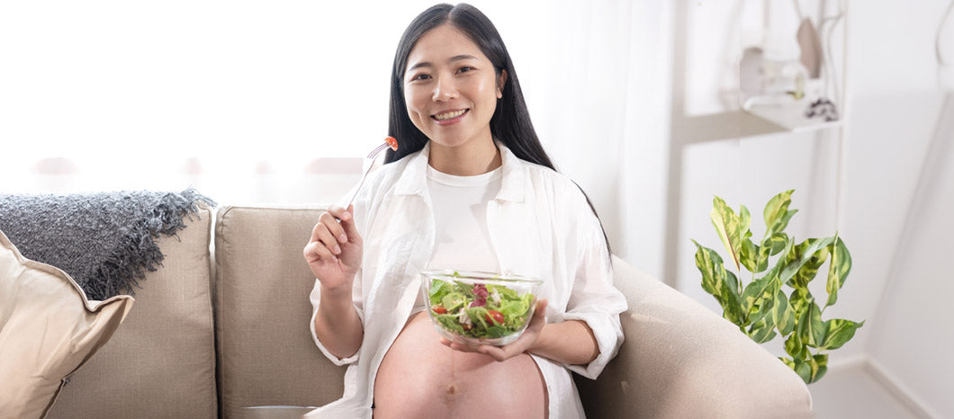 pregnant woman eating healthy salad