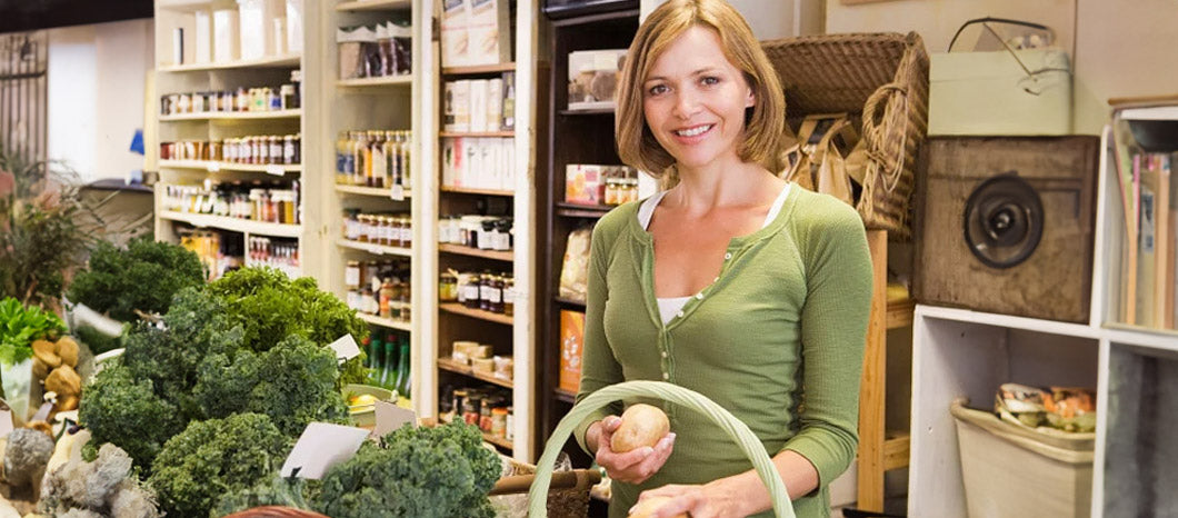 woman in grocery store in vegetable section