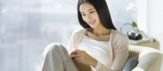 woman reading about ovulation and fertility